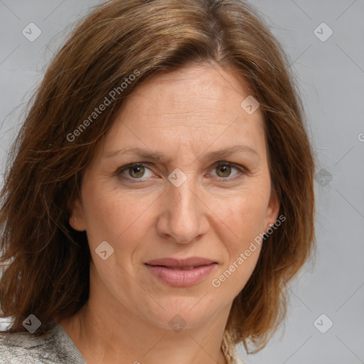 Joyful white adult female with medium  brown hair and blue eyes