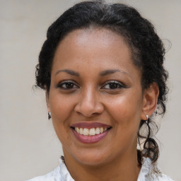 Joyful black young-adult female with medium  brown hair and brown eyes