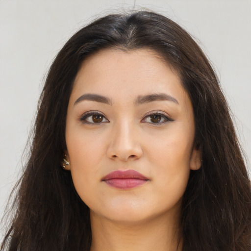 Joyful latino young-adult female with long  brown hair and brown eyes