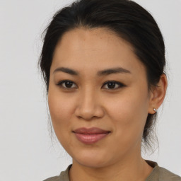 Joyful asian young-adult female with medium  brown hair and brown eyes