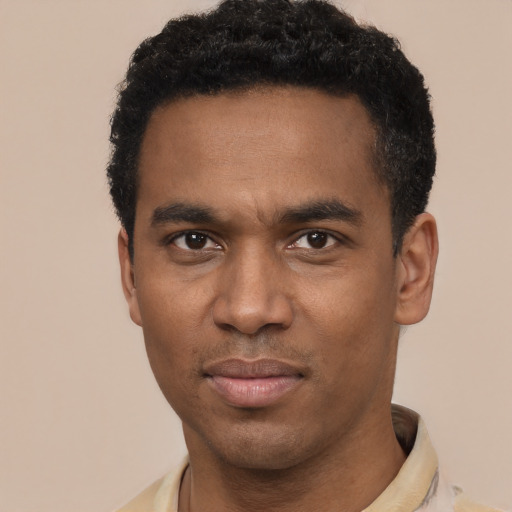 Joyful black young-adult male with short  black hair and brown eyes