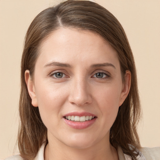 Joyful white young-adult female with medium  brown hair and grey eyes