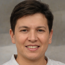 Joyful white adult male with short  brown hair and brown eyes