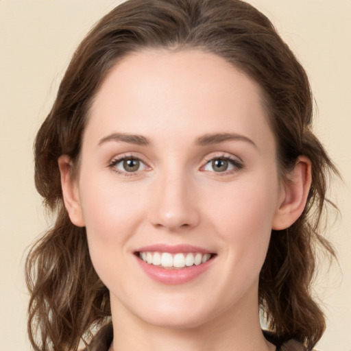 Joyful white young-adult female with medium  brown hair and green eyes