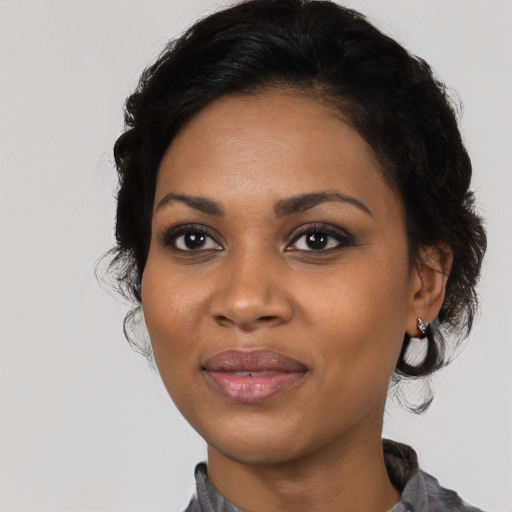 Joyful black young-adult female with medium  black hair and brown eyes