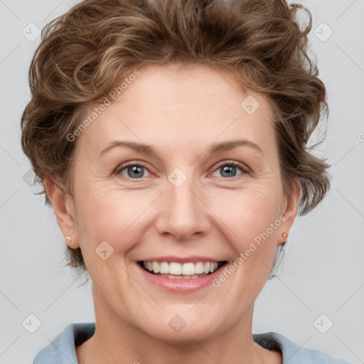 Joyful white adult female with medium  brown hair and blue eyes