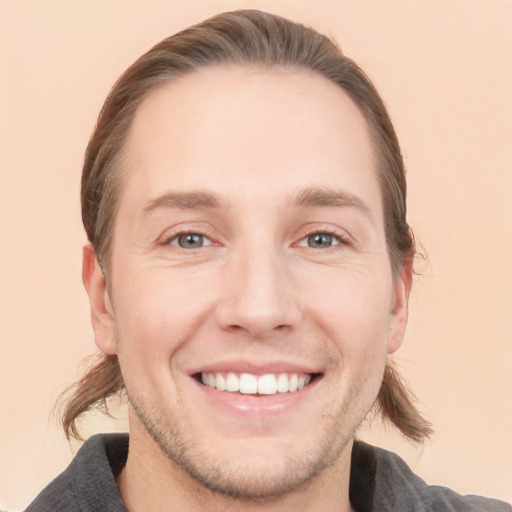 Joyful white adult male with short  brown hair and grey eyes