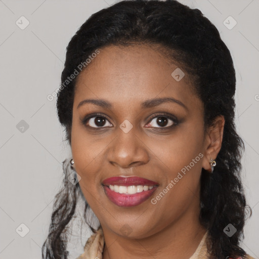 Joyful black young-adult female with long  black hair and brown eyes