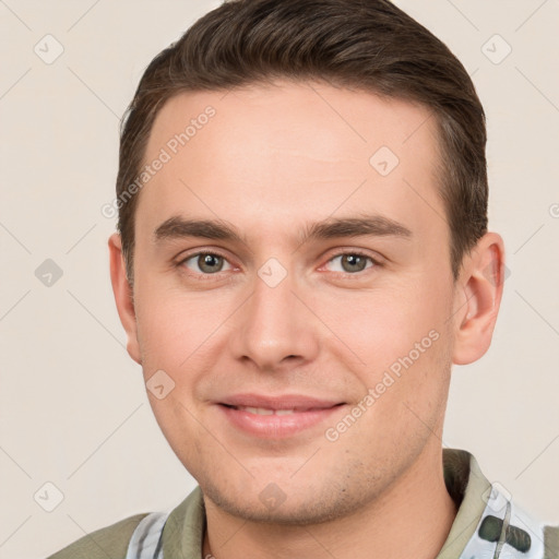 Joyful white young-adult male with short  brown hair and grey eyes