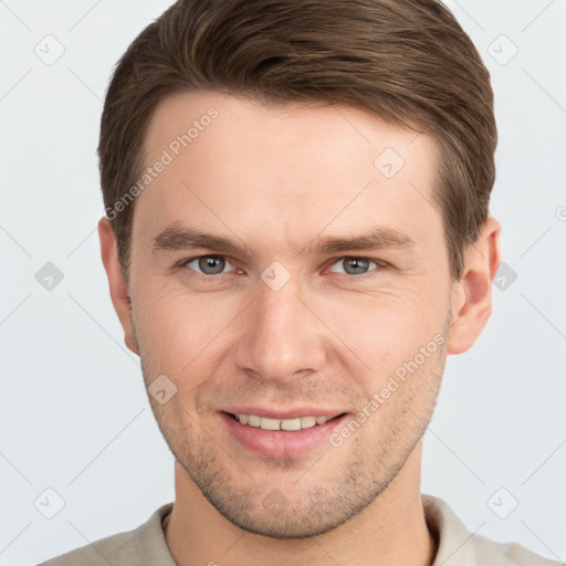 Joyful white young-adult male with short  brown hair and grey eyes