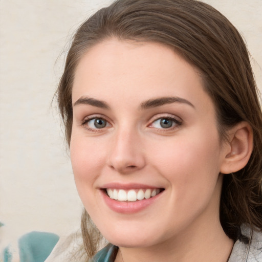 Joyful white young-adult female with medium  brown hair and blue eyes