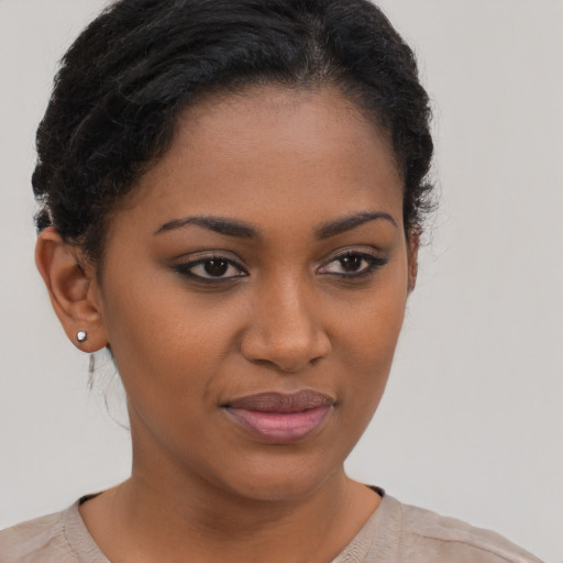 Joyful black young-adult female with short  brown hair and brown eyes