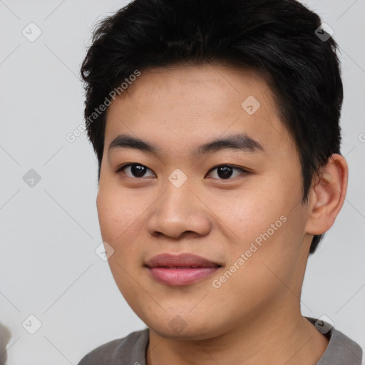 Joyful asian young-adult male with short  black hair and brown eyes