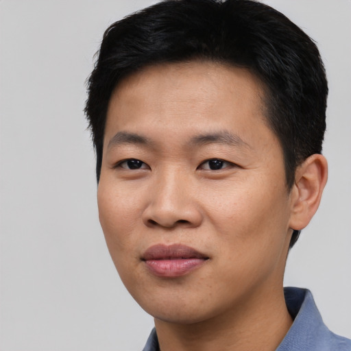 Joyful asian young-adult male with short  black hair and brown eyes