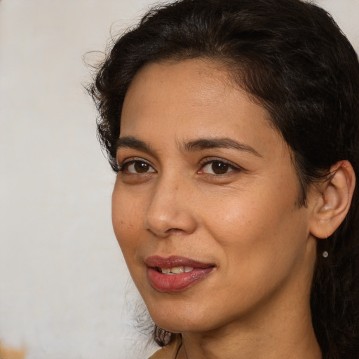 Joyful white adult female with medium  brown hair and brown eyes