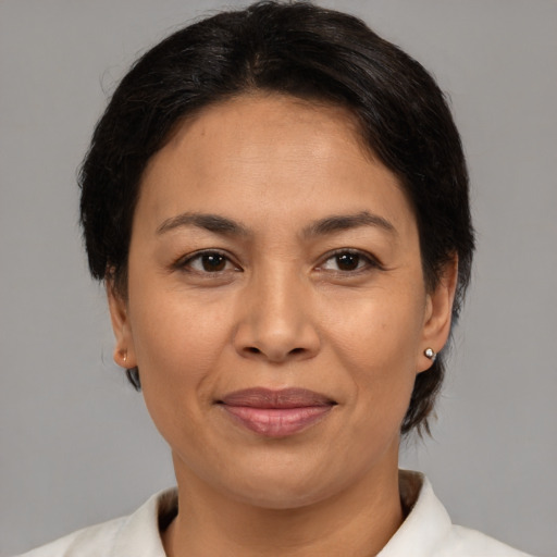 Joyful asian adult female with medium  brown hair and brown eyes