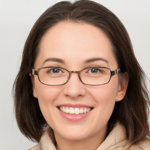 Joyful white young-adult female with medium  brown hair and grey eyes