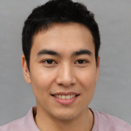 Joyful asian young-adult male with short  black hair and brown eyes