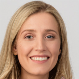 Joyful white young-adult female with long  brown hair and blue eyes