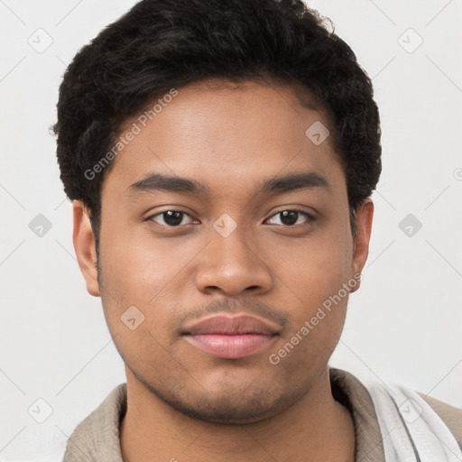 Joyful latino young-adult male with short  brown hair and brown eyes