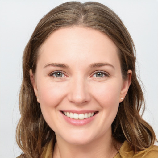 Joyful white young-adult female with long  brown hair and grey eyes