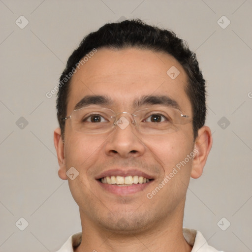 Joyful white young-adult male with short  black hair and brown eyes