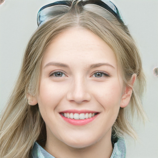 Joyful white young-adult female with long  brown hair and blue eyes