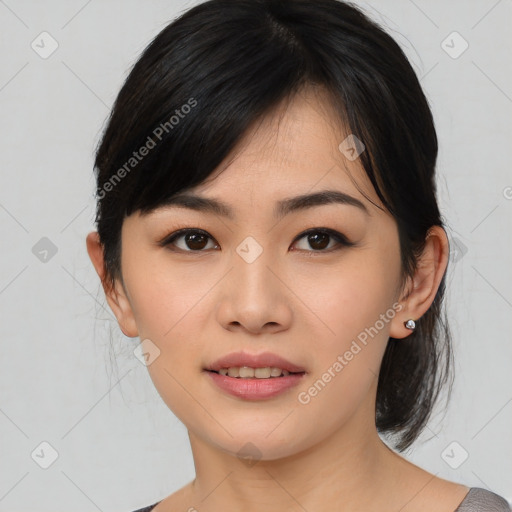 Joyful asian young-adult female with medium  black hair and brown eyes