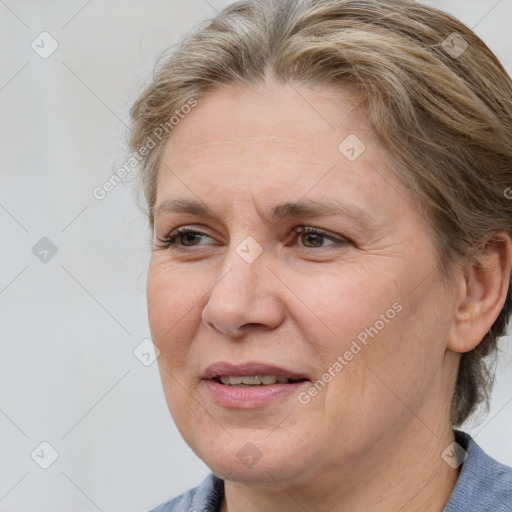 Joyful white adult female with medium  brown hair and blue eyes