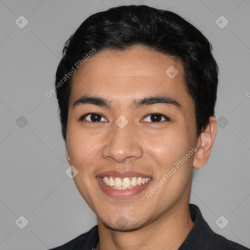 Joyful latino young-adult male with short  black hair and brown eyes