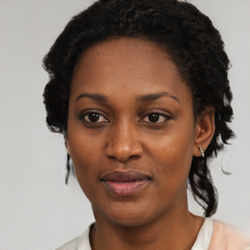 Joyful black adult female with short  black hair and brown eyes