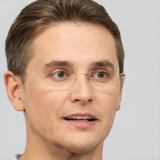 Joyful white adult male with short  brown hair and grey eyes