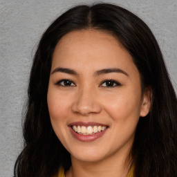 Joyful asian young-adult female with long  brown hair and brown eyes