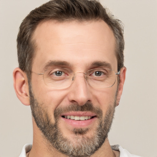 Joyful white adult male with short  brown hair and brown eyes