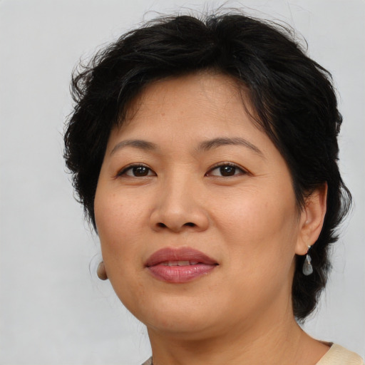 Joyful asian adult female with medium  brown hair and brown eyes