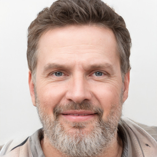 Joyful white adult male with short  brown hair and grey eyes