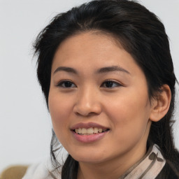 Joyful asian young-adult female with medium  brown hair and brown eyes