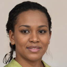 Joyful black young-adult female with medium  brown hair and brown eyes