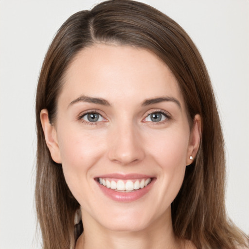 Joyful white young-adult female with long  brown hair and grey eyes