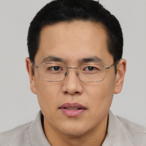 Neutral asian adult male with short  brown hair and brown eyes