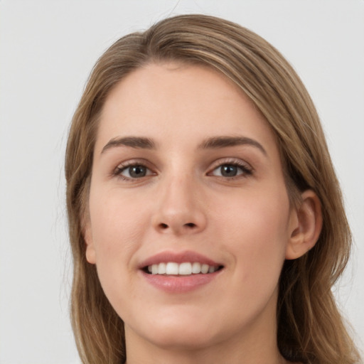 Joyful white young-adult female with long  brown hair and grey eyes