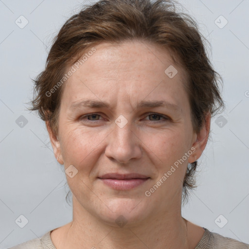 Joyful white adult female with short  brown hair and grey eyes