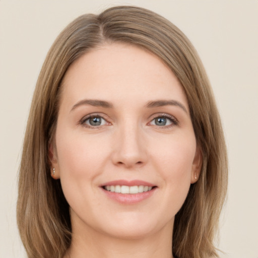 Joyful white young-adult female with long  brown hair and grey eyes