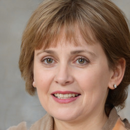 Joyful white adult female with medium  brown hair and grey eyes