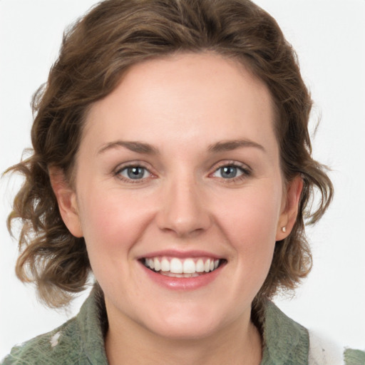 Joyful white young-adult female with medium  brown hair and green eyes