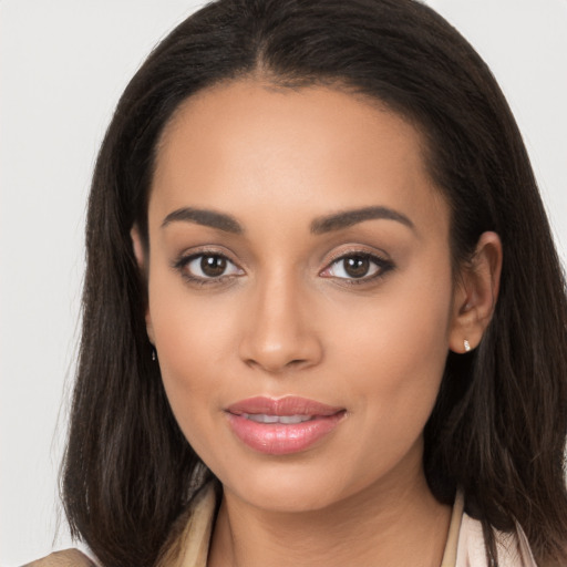 Joyful latino young-adult female with long  brown hair and brown eyes