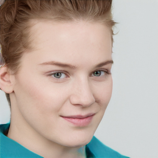 Joyful white young-adult female with short  brown hair and blue eyes