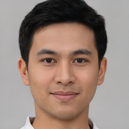 Joyful asian young-adult male with short  brown hair and brown eyes