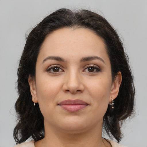 Joyful latino young-adult female with medium  brown hair and brown eyes