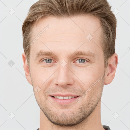 Joyful white adult male with short  brown hair and grey eyes